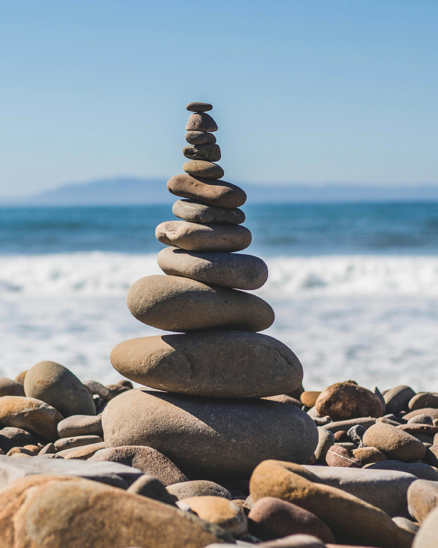 Stacked stones at the shore — calm and recovery