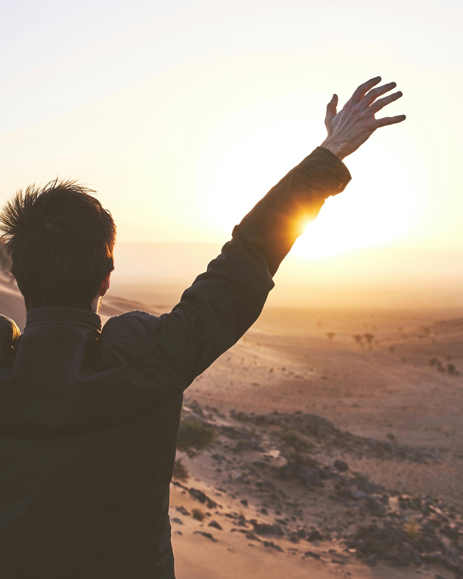 A person facing the sunrise — financial calm and momentum